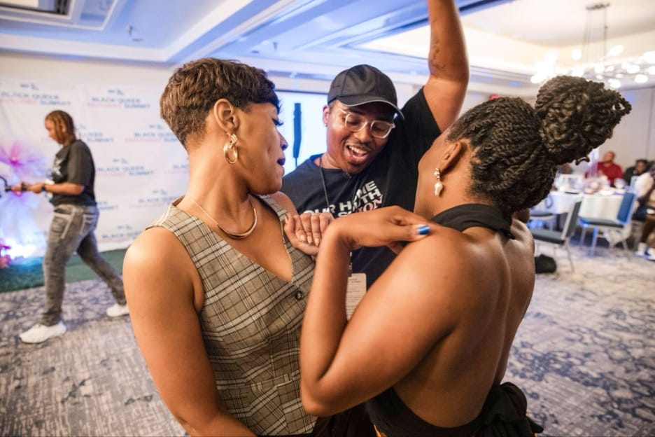 Dr. Joshua Baker (center), Youth Program Coordinator for TKO Society and an organizer of the Black Queer Visionaries Summit, revels in Black queer joy with attendees during day two of the inaugural event at the Embassy Suites in Birmingham, AL. | GLAAD Dr. Joshua Baker (center), Youth Program Coordinator for TKO Society and an organizer of the Black Queer Visionaries Summit, revels in Black queer joy with attendees during day two of the inaugural event at the Embassy Suites in Birmingham, AL.