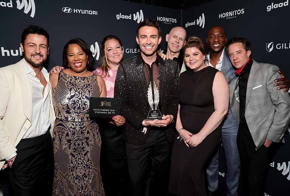 Tyler Hynes, Philicia Kennedy Flamer, Jonathan Bennett, Rick Garman, B.J. Britt and Ryan M. Murphy pose with the Outstanding Film – Streaming or TV award for "The Groomsmen" backstage during the 36th Annual GLAAD Media Awards at The Beverly Hilton on March 27, 2025 in Beverly Hills, California | GLAAD Tyler Hynes, Philicia Kennedy Flamer, Jonathan Bennett, Rick Garman, B.J. Britt and Ryan M. Murphy pose with the Outstanding Film – Streaming or TV award for "The Groomsmen" backstage during the 36th Annual GLAAD Media Awards at The Beverly Hilton on March 27, 2025 in Beverly Hills, California